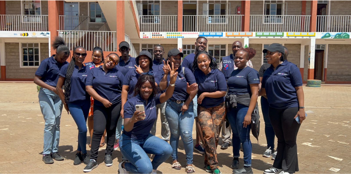 Value 8 Group team enjoying a photo session before interacting with children at Happy Life Christian School - Children's Home